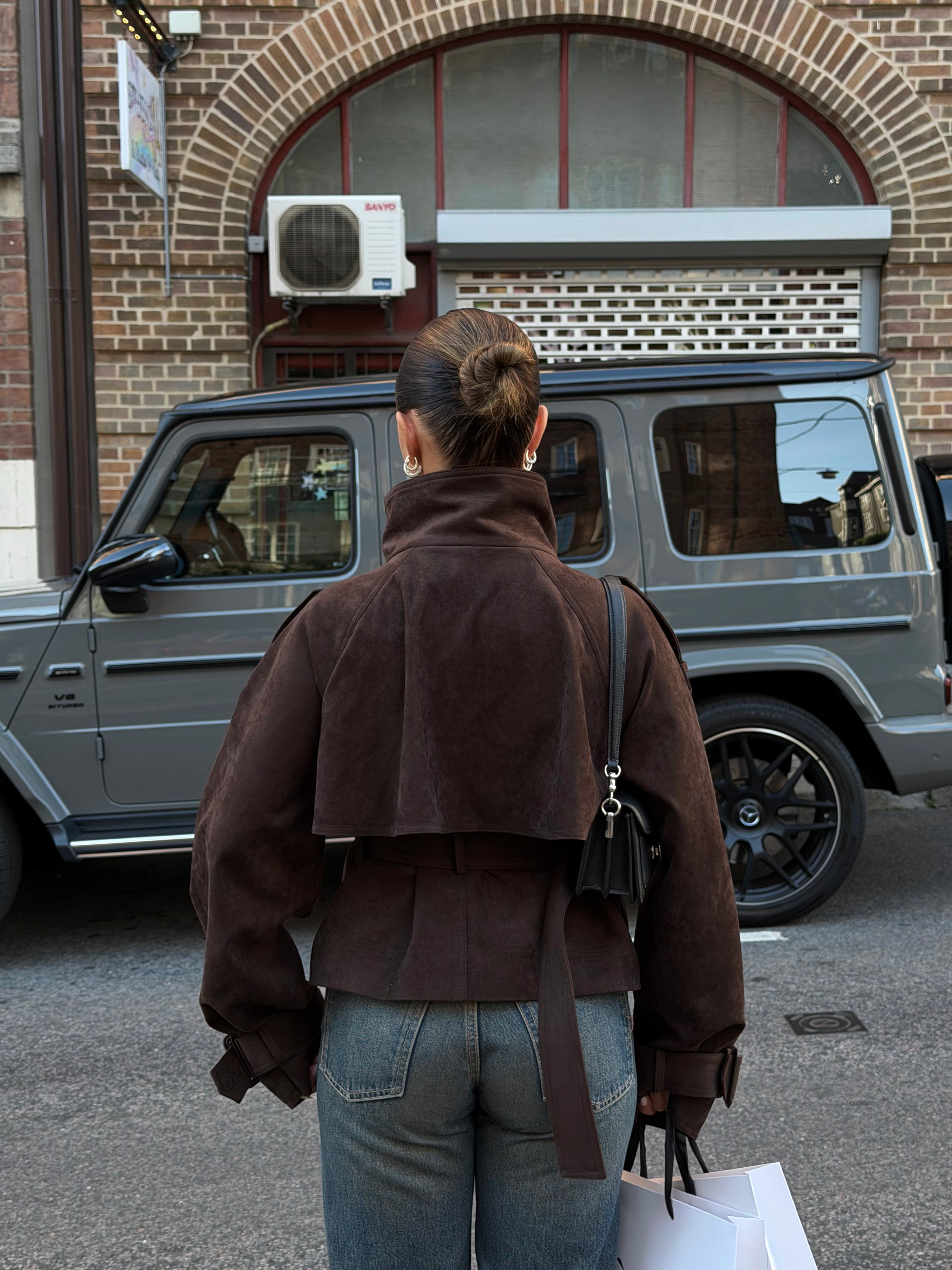 Back of the brown cropped belted jacket